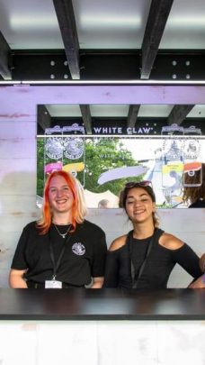 Image showing Viking Staffing & Events staff smiling behind a bar at a festival