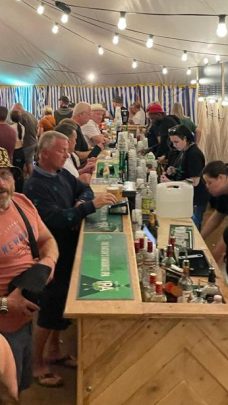 Image showing Viking Staffing & Events staff serving drinks in a tent at a festival