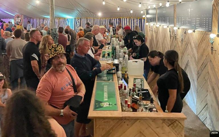 Image showing Viking Staffing & Events staff serving drinks in a tent at a festival