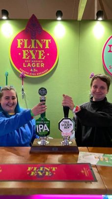 Image showing two Viking Staffing & Events staff pulling pints behind a bar at an event